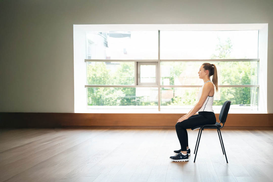 Frau die auf einem Stuhl sitzt