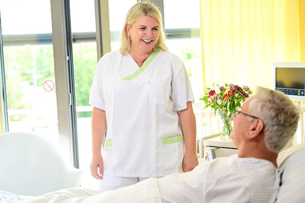 Pflegefachfrau der Urologie Planegg mit einem Patienten der stationär behandelt wird